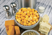 Three Cheese Poppin Popcorn in bowl on counter with ingredients