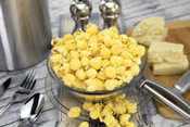 White Cheddar Poppin Popcorn in bowl on counter with ingredients